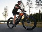 LANKELEISI RV800PLUS Black Orange fat tire e-bike riding near a forest road